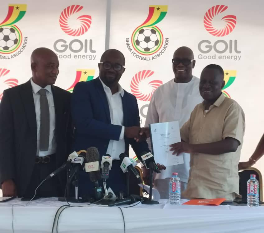 Kurt Okraku, GFA President receiving a copy of the partnership agreement from Kwame Osei Prempeh, Group CEO and MD OF GOIL. Looking in are Mark Addo, GFA Vice President (far left) and Reginald Daniel Laryea, GOIL Board Chairman